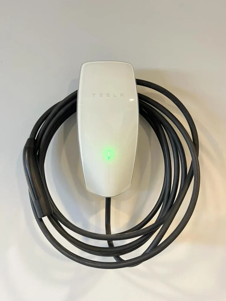A ev home charger installation with a green light attached to it.